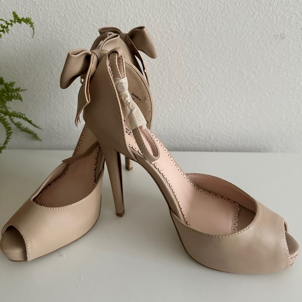 Peep toe ankle strap with bow tie heel